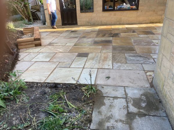 Our patio team installing a patio in Eight Ash Green